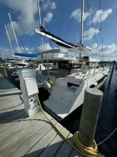 2020 Leopard 50 catamaran docked at marina under blue sky.