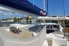2022 Leopard 45 yacht deck with seating and helm, docked in a marina.