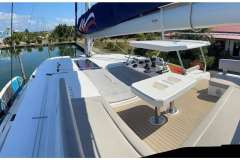 Luxurious 2022 Leopard 45 catamaran with spacious deck and modern amenities docked by the water.