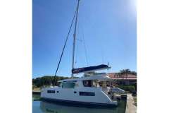 2022 Leopard 45 catamaran docked under clear blue sky.