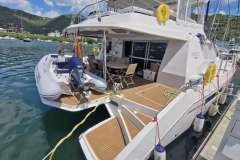 Luxury Leopard 58 yacht docked, featuring a spacious deck and tender boat, 2020 model.