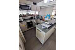 Modern kitchen in a 2020 Leopard 58 yacht, featuring appliances and ample counter space.
