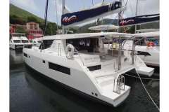 2020 Leopard 45 catamaran docked in marina, surrounded by lush green hills.