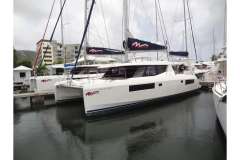 2020 Leopard 45 catamaran docked in marina, featuring sleek design and modern sails.