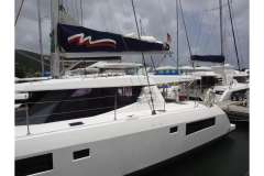 2020 Leopard 45 catamaran docked at marina under cloudy sky.