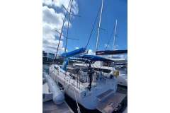 2024 Beneteau Oceanis 461 sailboat docked under a clear blue sky.