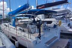 2024 Beneteau Oceanis 461 sailboat docked, featuring blue canopy and modern design.