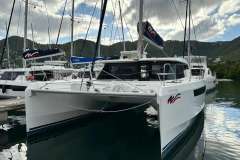 2021 Leopard 50 catamaran docked in a marina, surrounded by scenic mountains.