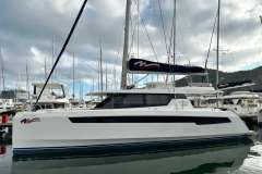 2021 Leopard 50 catamaran docked at marina, surrounded by other boats under cloudy sky.
