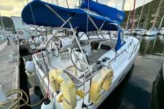 2024 Beneteau Oceanis 46.1 sailboat docked at marina, featuring blue canopy and modern design.