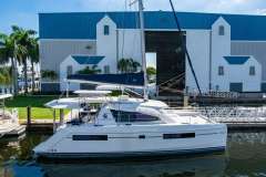 2016 Leopard 40 catamaran docked near a large blue and white building.