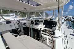Helm of 2018 Leopard 45 catamaran with navigation equipment and marina view.