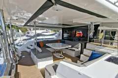 Spacious 2018 Leopard 45 yacht interior with modern seating and table arrangement.