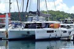 2018 Leopard 45 catamaran docked at marina with kayak on deck.