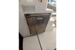 Stainless steel appliance on 2022 Leopard 45 yacht, near steps and seating area.