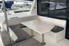 2020 Leopard 40 yacht with outdoor seating and table, docked at marina.