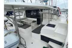 2020 Leopard 40 catamaran interior with seating area and table, docked at marina.