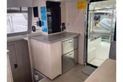 Interior of 2020 Leopard 40 catamaran with modern kitchen and outdoor view.
