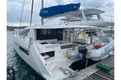 2020 Leopard 40 catamaran docked, featuring a dinghy and Sunsail branding.