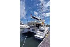 2022 Leopard 42 catamaran docked at marina under clear blue sky.