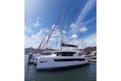2022 Leopard 42 catamaran docked at marina under clear blue sky.