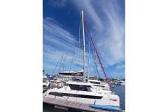 2022 Leopard 42 catamaran docked at marina under clear blue sky.