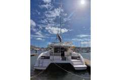 2022 Leopard 42 catamaran docked under a sunny sky in a marina.