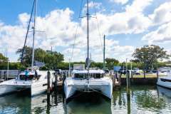 2025 Leopard 46 catamaran docked at marina under blue sky.