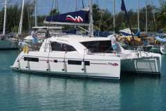 2019 Leopard 40 catamaran docked in marina with two people on deck.