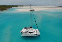 Leopard 40 catamaran sailing in turquoise waters near a sandy beach, 2020 model.