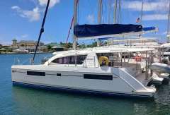 2019 Leopard 40 catamaran docked in a marina under a clear blue sky.