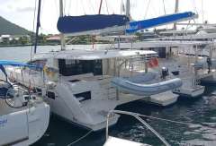 2019 Leopard 40 catamaran docked with dinghy, surrounded by other boats.