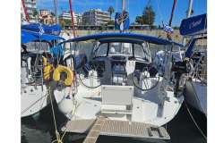 2019 Beneteau Oceanis 41.1 sailboat docked in a marina, featuring dual steering wheels.