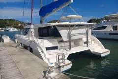 2018 Leopard 45 catamaran docked at marina, featuring spacious deck and modern design.