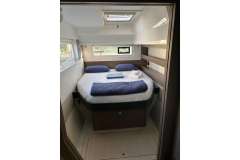 Cozy bedroom in 2022 Leopard 42 yacht with modern design and natural light.