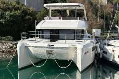 2024 Leopard 40 Powercat yacht docked in a serene marina setting.