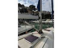 2009 Bavaria 35 Cruiser sailboat docked in a marina, surrounded by other boats.