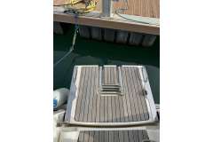Bavaria 35 Cruiser 2009 swim platform with ladder, docked at marina.