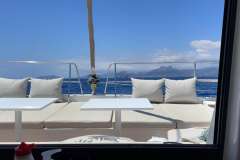 Luxurious Bali 4.1 catamaran deck with cushions, tables, and ocean view, 2019 model.