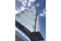 Sail of a 2019 Bali 4.1 catamaran against a blue sky.