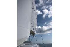 Sailing on a 2019 Bali 4.1 catamaran under a partly cloudy sky.