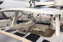 2017 Hanse 588 yacht with dual steering wheels and spacious deck at a marina.
