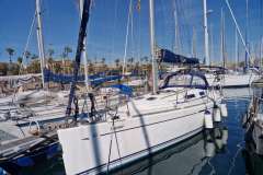2006 Dufour 40 Performance sailboat docked in a marina under clear blue skies.