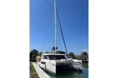 2022 Leopard 45 catamaran docked under clear blue sky.