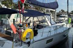 2017 Beneteau Oceanis 48 sailboat docked, featuring a sleek design and vibrant flags.