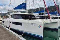 2020 Leopard 45 catamaran docked at marina with scenic mountain backdrop.