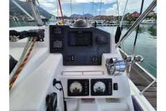 Helm of a 2020 Leopard 45 catamaran with navigation instruments and marina view.