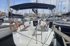 2008 Dufour 325 Grand Large sailboat docked in a marina, featuring a spacious cockpit.