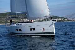 Sailing yacht Hanse 588, 2017 model, cruising in scenic coastal waters.