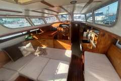 Interior of 1983 Jeanneau Espace 1000 sailboat with cozy seating and wooden finishes.